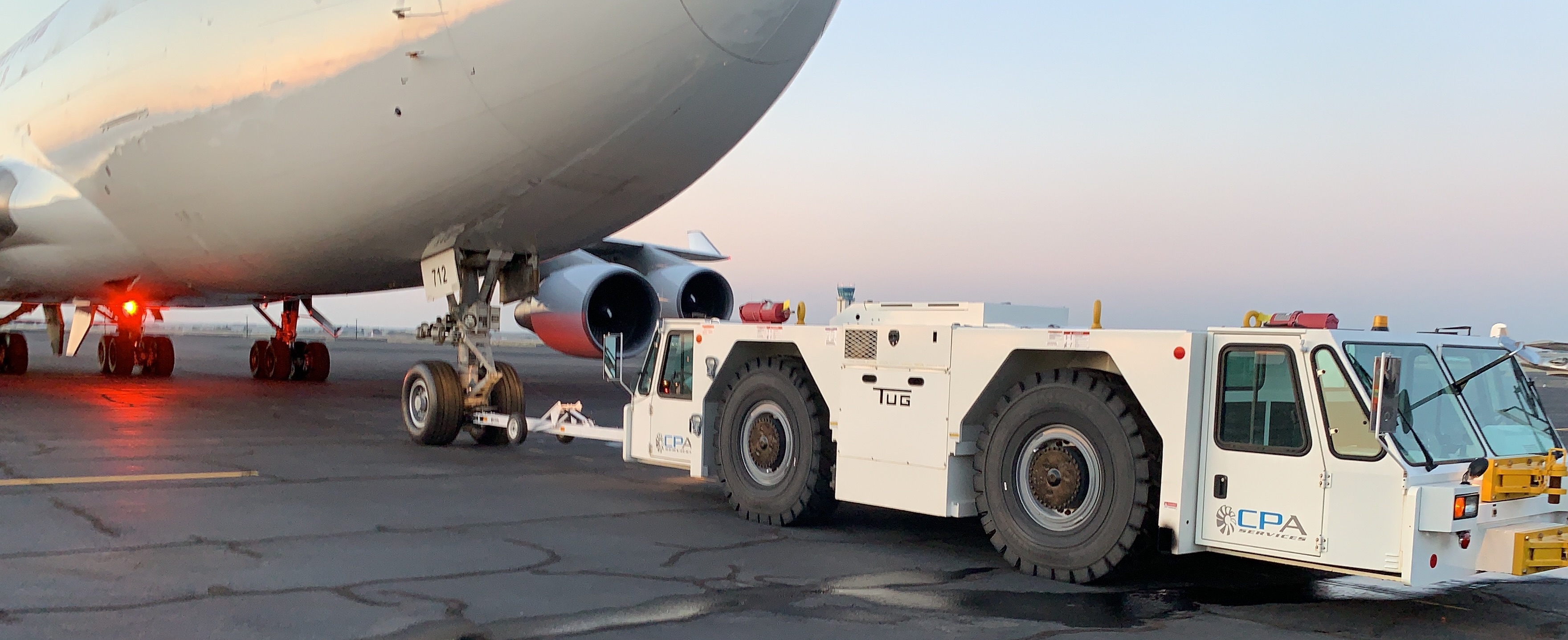 TUG/Textron GT110 pushback tug pushing back a loaded B747.