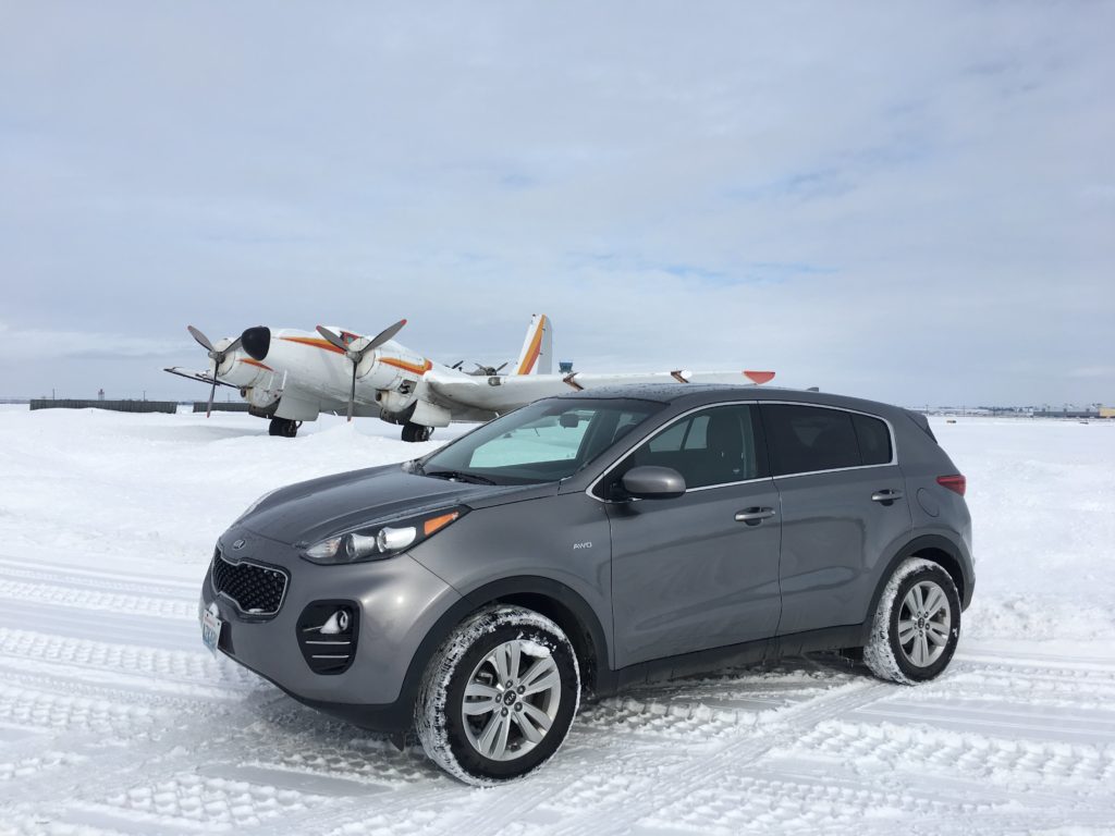 All-wheel-drive Kia Sportage in front of the only flying Douglas B-23.