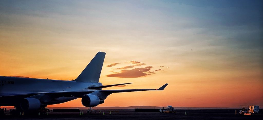 B747 and cargo dollies, loaded at sunset.